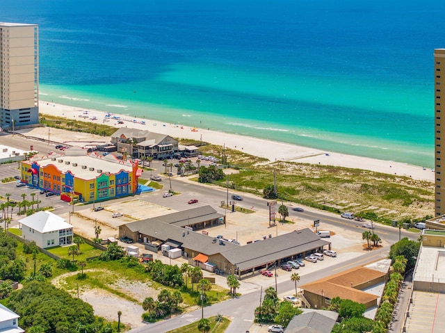 birds eye view of property featuring a beach view and a water view