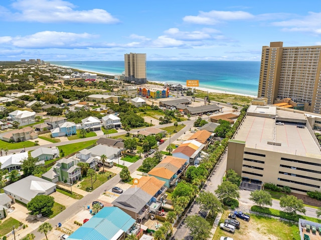 drone / aerial view with a beach view and a water view