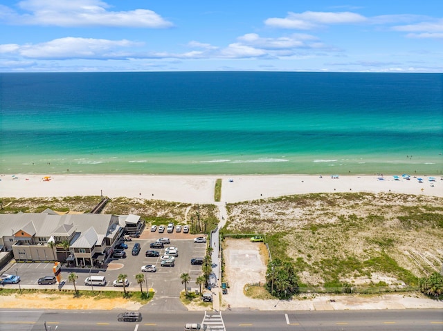 birds eye view of property featuring a beach view and a water view