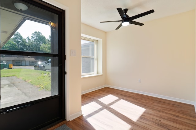 doorway to outside featuring ceiling fan and light hardwood / wood-style floors