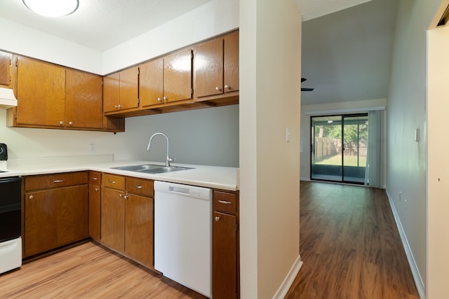 kitchen with light hardwood / wood-style flooring, sink, and white appliances