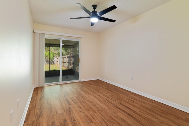 spare room featuring ceiling fan, hardwood / wood-style flooring, and a textured ceiling