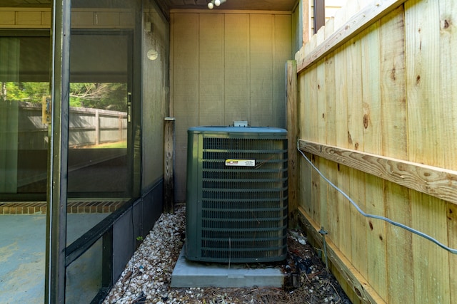 details featuring central AC and wooden walls