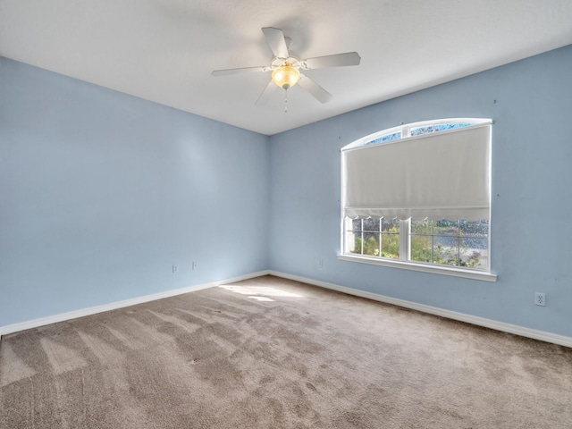 carpeted empty room featuring ceiling fan