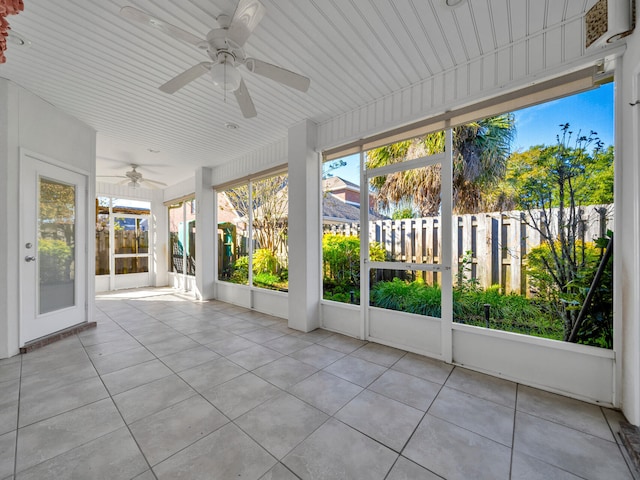 unfurnished sunroom with ceiling fan and wood ceiling