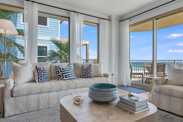 living room with a water view and carpet floors