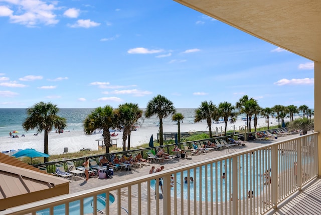 view of pool featuring a view of the beach and a water view