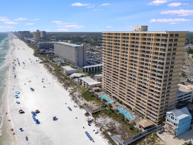 drone / aerial view featuring a water view and a view of the beach