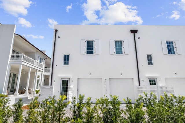 view of front of home with a balcony and a garage