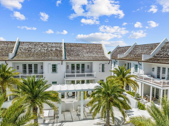 back of property with a balcony and a patio area