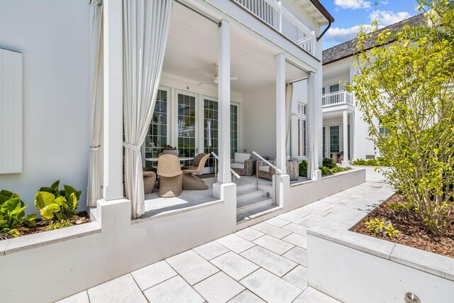 view of patio with a balcony and ceiling fan