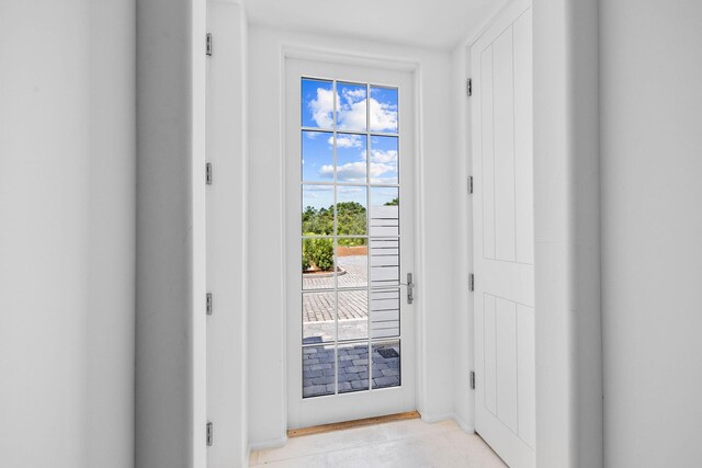 doorway featuring light tile patterned floors