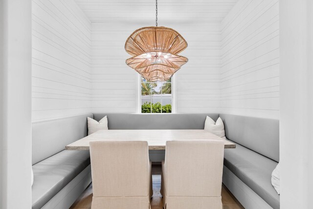 tiled dining space with an inviting chandelier and breakfast area