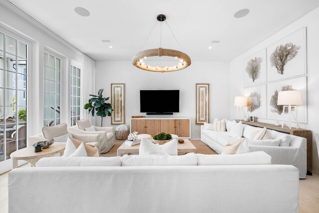 living room with a chandelier and light carpet