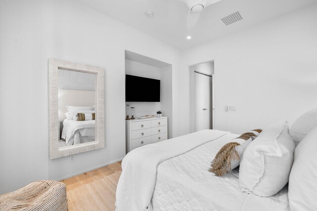 bedroom with light hardwood / wood-style flooring and ceiling fan