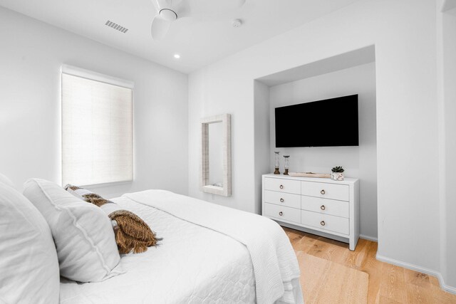 bedroom with light wood-type flooring and ceiling fan