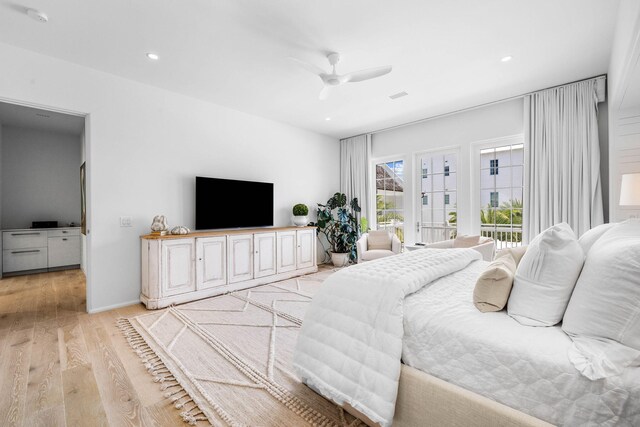 bedroom featuring light hardwood / wood-style flooring, ceiling fan, and access to outside