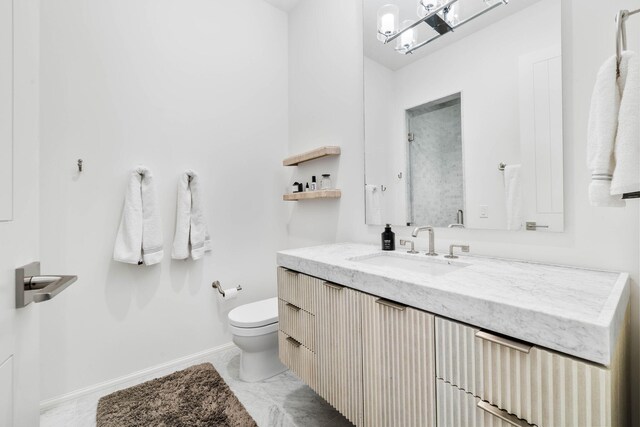 bathroom featuring toilet and vanity