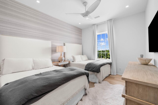 bedroom with light wood-type flooring and ceiling fan