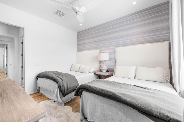 bedroom with light wood-type flooring and ceiling fan