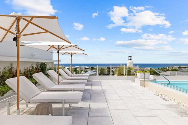 view of patio with a water view and a fenced in pool