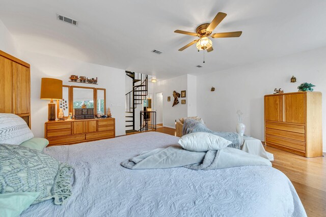 bedroom with light hardwood / wood-style flooring and ceiling fan