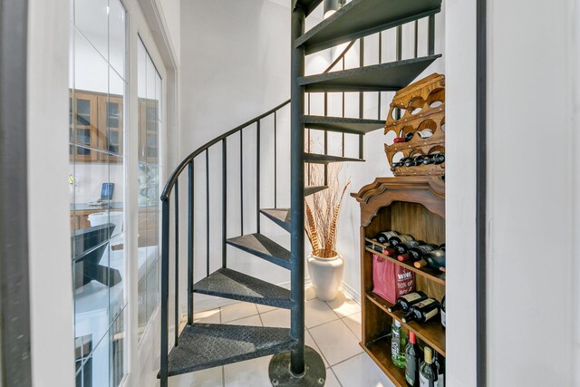 staircase featuring tile patterned flooring