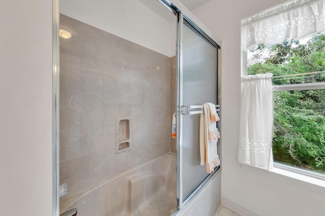 664 Woodland Bayou Dr, Santa Rosa Beach, FL 32459 - bathroom with baseboards and combined bath / shower with glass door
