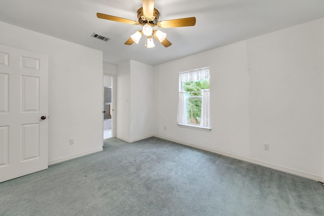 spare room with ceiling fan and light colored carpet