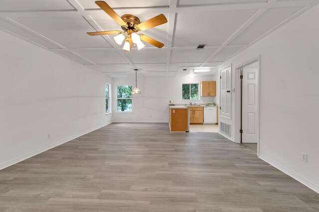 unfurnished living room with ceiling fan, sink, coffered ceiling, and light wood-type flooring