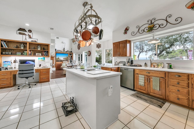 664 Woodland Bayou Dr, Santa Rosa Beach, FL 32459 - kitchen with light countertops, stainless steel dishwasher, brown cabinetry, and light tile patterned flooring