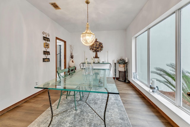 dining room featuring hardwood / wood-style floors and a notable chandelier