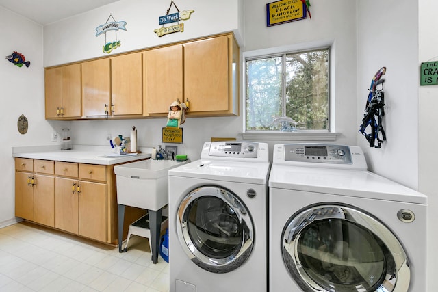 664 Woodland Bayou Dr, Santa Rosa Beach, FL 32459 - laundry area featuring washing machine and dryer, cabinet space, and light tile patterned floors