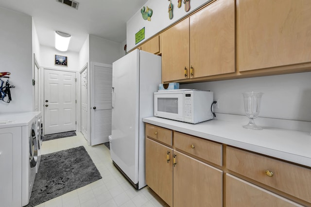 664 Woodland Bayou Dr, Santa Rosa Beach, FL 32459 - kitchen with washing machine and clothes dryer, white appliances, light countertops, and visible vents