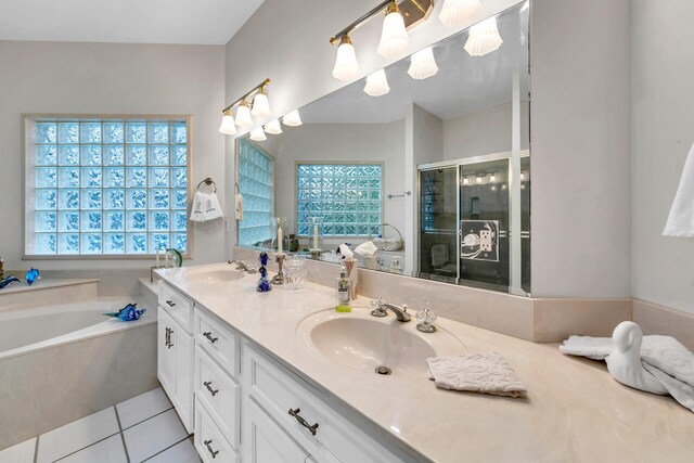 bathroom with plus walk in shower, vanity, and tile patterned floors