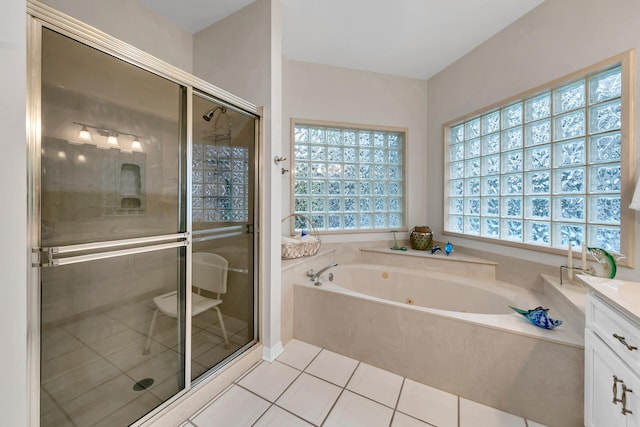 bathroom featuring tile patterned flooring, vanity, and shower with separate bathtub