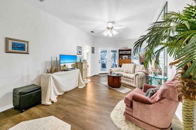 living room with ceiling fan and dark wood-type flooring