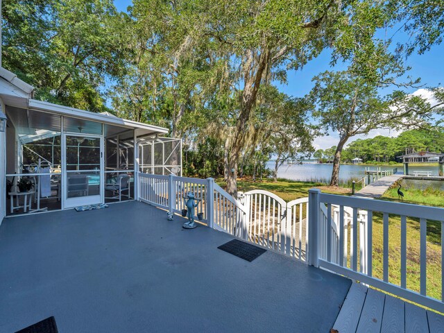 view of patio with a water view and a lanai