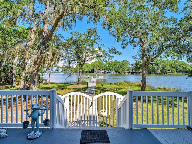 664 Woodland Bayou Dr, Santa Rosa Beach, FL 32459 - wooden deck featuring a water view and a lawn