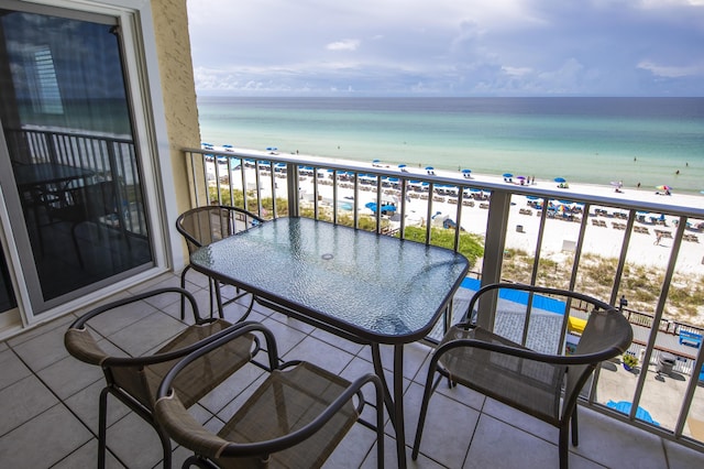 balcony with view of water and beach