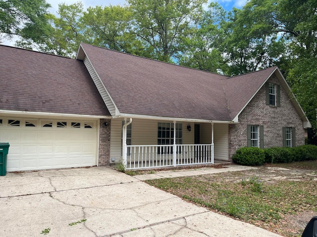 view of front facade with a garage and a porch