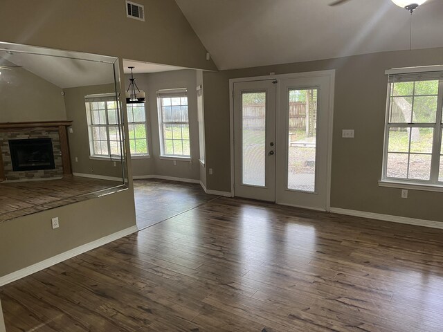 unfurnished living room with lofted ceiling, plenty of natural light, ceiling fan, and dark hardwood / wood-style flooring