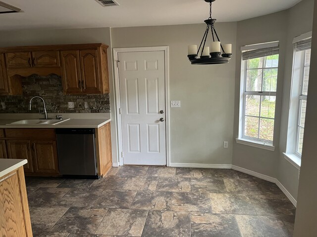 kitchen featuring dishwasher, a healthy amount of sunlight, backsplash, and sink