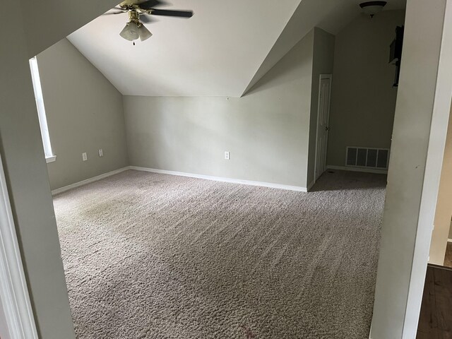 additional living space with lofted ceiling, ceiling fan, and carpet