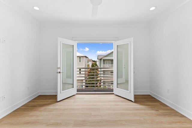 spare room featuring ornamental molding, ceiling fan, and light hardwood / wood-style floors