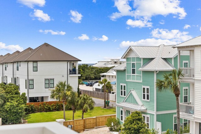 exterior space featuring a balcony and a yard