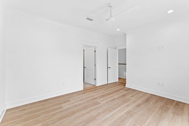 empty room with crown molding, light hardwood / wood-style flooring, and ceiling fan