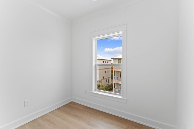 empty room with light hardwood / wood-style flooring