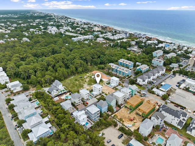 bird's eye view with a water view and a beach view