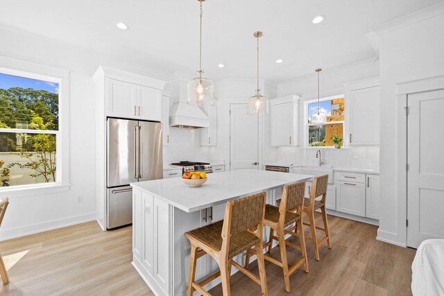 kitchen with plenty of natural light, stainless steel appliances, and white cabinets